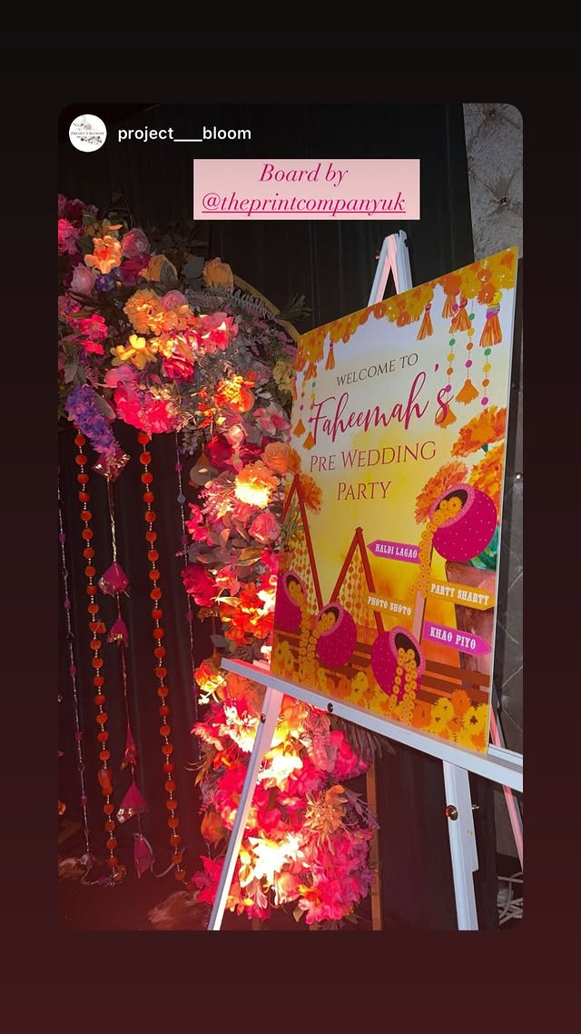 A colourful personalised pre-wedding board printed by The Print Company and displayed beside event decor